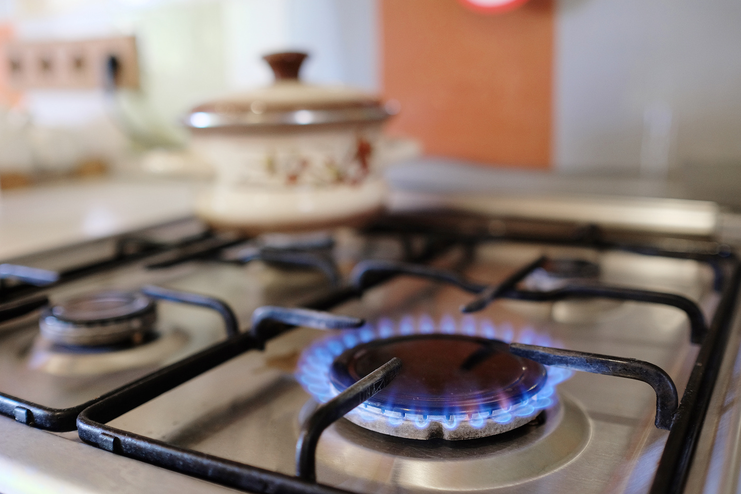 A closeup of a lit gas stove burner